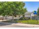 Charming home with a well-maintained front yard, mature tree, and a welcoming exterior at 4849 S Pitkin Way, Aurora, CO 80015