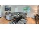 Spacious living area with a large sectional sofa, hardwood floors, and ample natural light at 4849 S Pitkin Way, Aurora, CO 80015