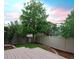 Private backyard features a deck, privacy fence and a beautiful lush lawn at 849 Canary Ln, Brighton, CO 80601