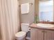 Cozy bathroom with white shower curtain, granite counter top, and neutral walls at 849 Canary Ln, Brighton, CO 80601