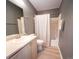 Well-maintained bathroom featuring neutral walls, updated vanity, toilet, and shower with white shower curtain at 849 Canary Ln, Brighton, CO 80601
