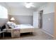 Bedroom with decorative pillows, neutral walls, and access to walk-in closet at 849 Canary Ln, Brighton, CO 80601