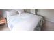 Bright bedroom features a comfortable bed with decorative pillows, complemented by neutral walls and cozy carpeting at 849 Canary Ln, Brighton, CO 80601