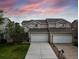 Inviting home exterior featuring a well-maintained lawn and a two-car garage at 849 Canary Ln, Brighton, CO 80601