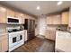 Well-lit kitchen featuring stainless steel appliances and wood-look flooring at 849 Canary Ln, Brighton, CO 80601