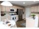 Bright kitchen features stainless steel appliances and white countertops at 849 Canary Ln, Brighton, CO 80601