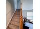 Carpeted staircase leading to upper level with window view at 849 Canary Ln, Brighton, CO 80601
