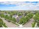 Aerial view of the house nestled among trees in a residential area with a view of the city skyline at 2908 N Florence St, Denver, CO 80238
