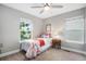 Comfortable bedroom with neutral walls and bright windows with view of the outside greenery at 2908 N Florence St, Denver, CO 80238