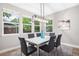 Bright dining room with modern light fixture and lots of natural light with seating for six at 2908 N Florence St, Denver, CO 80238