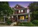 Charming two-story home with a front porch, brick accents, and well-manicured landscaping at 2908 N Florence St, Denver, CO 80238