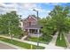 Two story home with a brick foundation and a covered porch, enhancing curb appeal at 2908 N Florence St, Denver, CO 80238