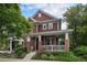 Charming two-story home with a front porch, brick accents, and well-manicured landscaping at 2908 N Florence St, Denver, CO 80238
