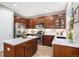 Updated kitchen with wood cabinets, stainless steel appliances, and a white quartz island at 2908 N Florence St, Denver, CO 80238
