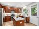 Modern kitchen with wood cabinets, stainless steel appliances, and a white quartz island at 2908 N Florence St, Denver, CO 80238