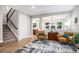Open living room with hardwood floors, a large rug, and views into the kitchen at 2908 N Florence St, Denver, CO 80238