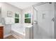 Elegant bathroom featuring tub, walk-in shower, and natural light from large windows at 2908 N Florence St, Denver, CO 80238
