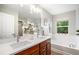 Bright bathroom featuring double sinks, a soaking tub, and a separate glass shower at 2908 N Florence St, Denver, CO 80238