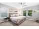 Inviting main bedroom with plush bedding, ceiling fan, and bright windows overlooking trees at 2908 N Florence St, Denver, CO 80238