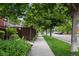 A street view with mature trees lining the sidewalk and well-kept lawns enhancing the neighborhood appeal at 2908 N Florence St, Denver, CO 80238