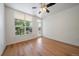 Bright bedroom with a ceiling fan, hardwood floors, and a balcony door at 1521 Vine St # 101, Denver, CO 80206
