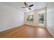 Comfortable bedroom with hardwood floors, a ceiling fan, and a balcony at 1521 Vine St # 101, Denver, CO 80206
