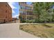 Multi-story building with balconies, manicured landscaping and a view of the parking area at 1521 Vine St # 101, Denver, CO 80206