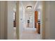 Hallway view showcasing neutral walls and trim, tile floors, and wooden cabinets at 1521 Vine St # 101, Denver, CO 80206