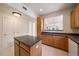 Kitchen with center island, wood cabinets and pass through to the dining area at 1521 Vine St # 101, Denver, CO 80206