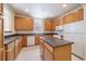 Functional kitchen with an island, ample wooden cabinetry, and tiled flooring at 1521 Vine St # 101, Denver, CO 80206