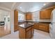 Spacious kitchen with wooden cabinets, center island, and view to living area at 1521 Vine St # 101, Denver, CO 80206
