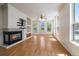 Bright living room with hardwood floors, a fireplace, built-in shelving, and plenty of natural light at 1521 Vine St # 101, Denver, CO 80206