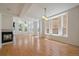 Open living room with a fireplace, hardwood floors, and large windows for ample natural light at 1521 Vine St # 101, Denver, CO 80206