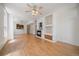 Spacious living room featuring hardwood floors, a fireplace, a ceiling fan, and an open layout at 1521 Vine St # 101, Denver, CO 80206