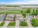 Eye-level view of neighborhood homes, lake, and railroad tracks, offering a serene living environment at 11285 Iola St, Commerce City, CO 80640