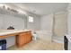Bathroom featuring tile flooring, bathtub, shower, vanity, and window at 11285 Iola St, Commerce City, CO 80640