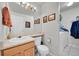 Functional bathroom with a single sink vanity, toilet, and adjacent laundry area with a washer and dryer at 11285 Iola St, Commerce City, CO 80640