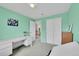Light and bright bedroom with mint-colored walls and closet space at 11285 Iola St, Commerce City, CO 80640