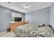 Bedroom with neutral tones, television, and natural light from window at 11285 Iola St, Commerce City, CO 80640