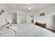 Bright bedroom with ceiling fan, adjacent bathroom, and wooden chest accent at 11285 Iola St, Commerce City, CO 80640