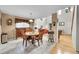 Cozy dining area featuring a round wooden table, vintage furniture, and natural light streaming through a large window at 11285 Iola St, Commerce City, CO 80640