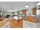 Open concept kitchen with an island that transitions to the living room. Stainless steel appliances at 11285 Iola St, Commerce City, CO 80640