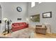 Bright living room features tall ceilings, natural light, and a comfortable seating arrangement with a sofa and armchairs at 11285 Iola St, Commerce City, CO 80640