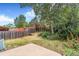 Lush backyard with a privacy fence, mature trees, and a small concrete patio area at 3713 S Ensenada St, Aurora, CO 80013