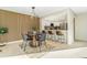 Modern dining area with a statement wood wall and stylish kitchen in the background at 3713 S Ensenada St, Aurora, CO 80013