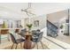 Open-concept dining room featuring a decorative chandelier and kitchen view at 3713 S Ensenada St, Aurora, CO 80013