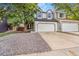 Charming two-story home featuring a spacious two-car garage and well-maintained gravel front yard at 3713 S Ensenada St, Aurora, CO 80013
