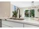 Bright kitchen with modern quartz countertops, black fixtures, and natural lighting at 3713 S Ensenada St, Aurora, CO 80013
