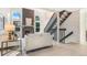 Bright living room featuring vaulted ceilings, a fireplace, and modern staircase at 3713 S Ensenada St, Aurora, CO 80013