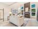 Sunlit living room featuring a stone fireplace, vaulted ceilings, and stylish decor at 3713 S Ensenada St, Aurora, CO 80013